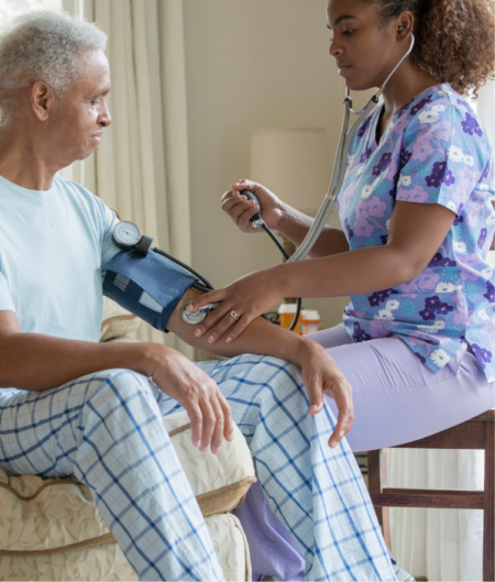 Young female nurse taking mans blood pressure