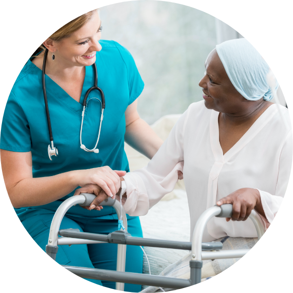 Female nurse helping female patient who is using a walker.