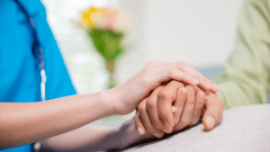 nurse holding patient hand