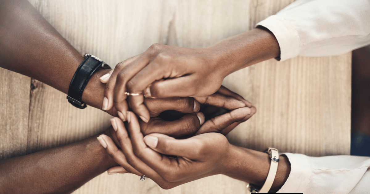 a close up image of hands holding each other